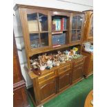 STAINED OAK ILLUMINATED DRESSER, TWO GLAZED DOORS AT THE TOP, THREE CUPBOARD DOORS AT THE BASE (