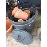 PLASTIC DUSTBIN WITH CONTENTS OF TERRACOTTA GARDEN POTS