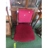 NURSING CHAIR WITH RED UPHOLSTERED SEAT AND BACK AND BRASS CASTORS