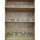 THREE SHELVES OF LILLIPUT LANE COTTAGE ORNAMENTS, SEVENTEEN IN TOTAL, INCLUDING THE TOYMENDERS AND
