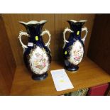 A PAIR OF FLORAL DECORATED TWO HANDLED VASES.