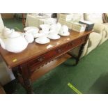 EDWARDIAN MAHOGANY TABLE WITH TWO DRAWERS TURNED LEGS, STRETCHED SHELF STANDING ON BROWN CHINA