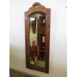 ARTS AND CRAFTS NARROW BEVELLED EDGED WALL MIRROR IN MAHOGANY FRAME.