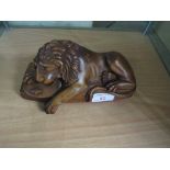 CARVED WOODEN FIGURE OF RECUMBENT LION WITH SHIELD (PERHAPS PART OF A DESK STAND)
