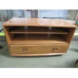 ERCOL LIGHT ELM TELEVISION STAND WITH SINGLE SHELF AND SINGLE DRAWER BENEATH.