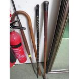 THREE VINTAGE WALKING CANES INCLUDING ONE WITH WHITE METAL CAP, AND A TRIBAL STYLE SPEAR