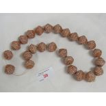 TWENTY-FIVE TERRACOTTA AND HAND DECORATED AFRICAN THREADED BEADS
