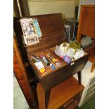 WOODEN SEWING BOX ON LEGS WITH CONTENTS OF CRAFT AND HOUSEHOLD OBJECTS