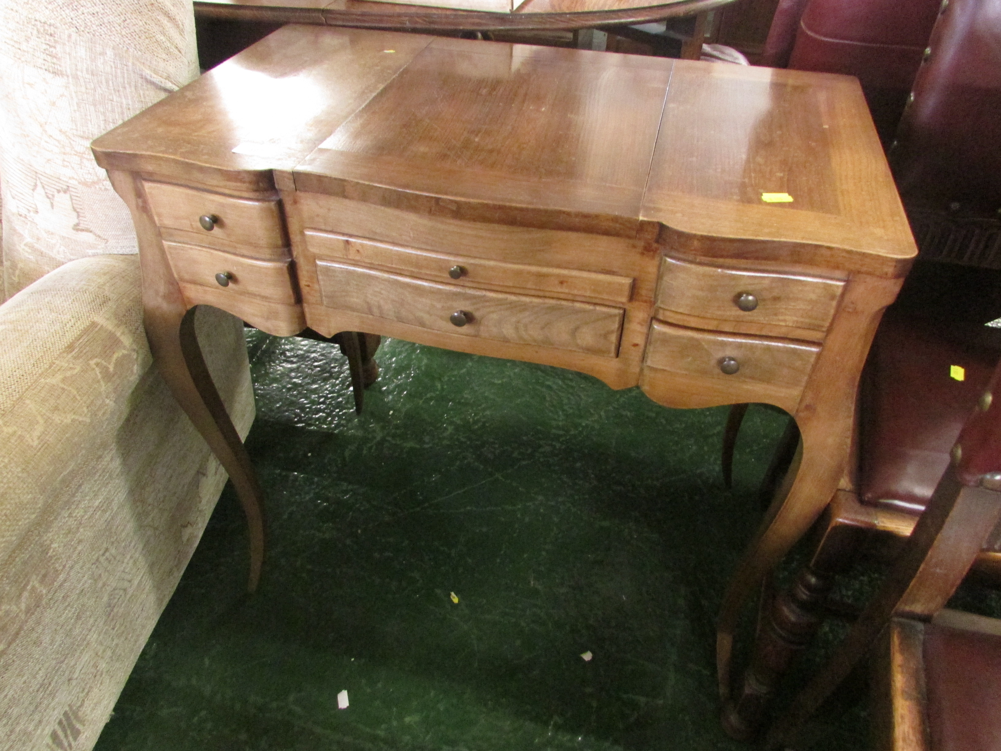 Mahogany dressing table with fold out mirror, storage compartments, two drawers and brush slide.