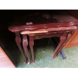 Nest three mahogany veneered occasional tables. As found