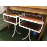 Pair of cream painted wrought metal two tiered bedside tables.