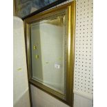 BEVELLED RECTANGULAR WALL MIRROR IN A DECORATIVE GILT EFFECT FRAME