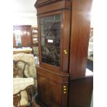 Mahogany veneered and boxwood strung corner cabinet with geometrically glazed door.