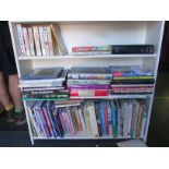 Three shelves of books about cooking, craft etc