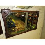 BEVELLED RECTANGULAR WALL MIRROR IN AN ART NOUVEAU STYLE CARVED OAK FRAME
