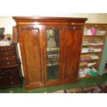 LARGE VICTORIAN MAHOGANY THREE DOOR WARDROBE WITH CENTRAL MIRRORED DOOR, CARVED DETAILS AND STANDING