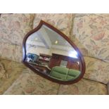 Shield shaped bevelled edged wall mirror in a mahogany and boxwood strung frame.