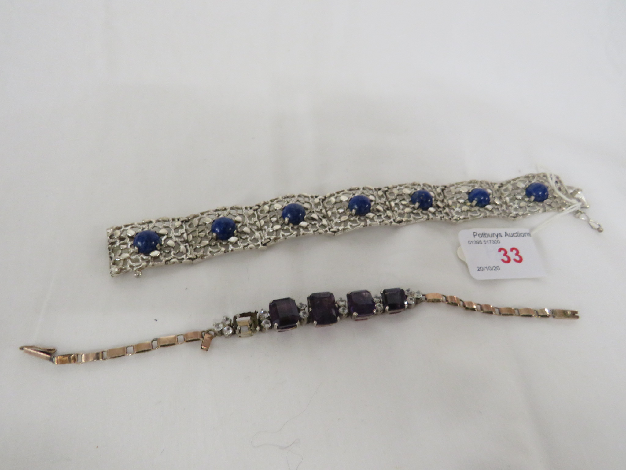 A FACETED AMETHYST BRACELET WITH GOLD-PLATED LINKS, AND A FRETWORK 835B WHITE METAL BRACELET SET