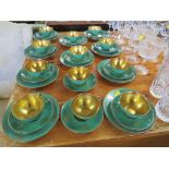 SWEDISH KARLSKRONA HALD PORCELAIN TWELVE CUPS AND SAUCERS AND TEN SIDE PLATES, GREEN AND GILT