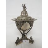 SILVER-PLATED LIDDED URN WITH MASK HEADS AND FIGURAL FINIAL