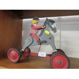 VINTAGE PULL ALONG TOY OF HORSE AND RIDER WITH FOUR WHEELS (SOLD AS AN ANTIQUE ITEM ONLY)