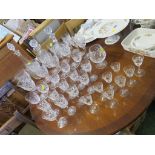 THREE CUT GLASS DECANTERS, WINE GLASSES AND SHERRY GLASSES ETC