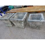 THREE COMPOSITE STONE SQUARE GARDEN PLANTERS