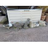 COMPOSITE STONE GARDEN ORNAMENTS; TWO OTTERS AND TWO BOOTS, TOGETHER WITH A CAST METAL DUCK