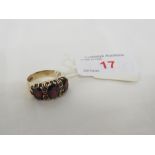 9 CARAT GOLD RING SET WITH THREE LARGE GARNETS AND FIVE SMALL GARNETS (ONE ABSENT), BRITISH