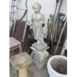 COMPOSITE STONE STATUE OF GIRL WITH ROSES, STANDING ON A PLINTH