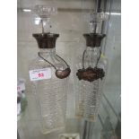 PAIR OF CUT GLASS SILVER MOUNTED DECANTERS WITH SILVER WHISKEY AND BRANDY LABELS