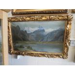 OIL ON CANVAS LANDSCAPE OF LAKE AND MOUNTAINS, SIGNED LOWER LEFT, IN A GILT WOOD FRAMED CARVED