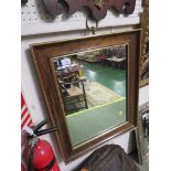 RECTANGULAR WALL MIRROR IN A MID WOOD FRAME WITH GILT BORDER