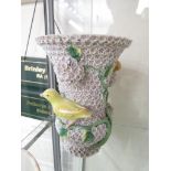 CONTINENTAL PORCELAIN - A PAIR OF VASES ENCRUSTED WITH FLOWERS AND MOULDED WITH YELLOW BIRDS WITH