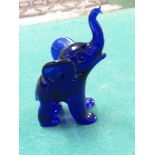 A BLUE GLASS MODEL OF A BABY ELEPHANT SIGNED TO FOOT