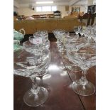 SET OF TWELVE COUPE GLASSES WITH FACETED STEMS