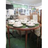 EDWARDIAN MAHOGANY CIRCULAR CARD TABLE, FOLDING TOP LINED WITH GREEN BAIZE, ON BROWN CHINA CASTERS