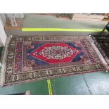 TURKISH TASPINAR RED AND BLUE GROUND THREE MARGIN WOOL RUG WITH CENTRAL MEDALLION (230CM X 121CM)