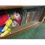 ONE SHELF OF ENID BLYTON AND LADYBIRD BOOKS, AND TWO PINKY AND PERKY DOLLS