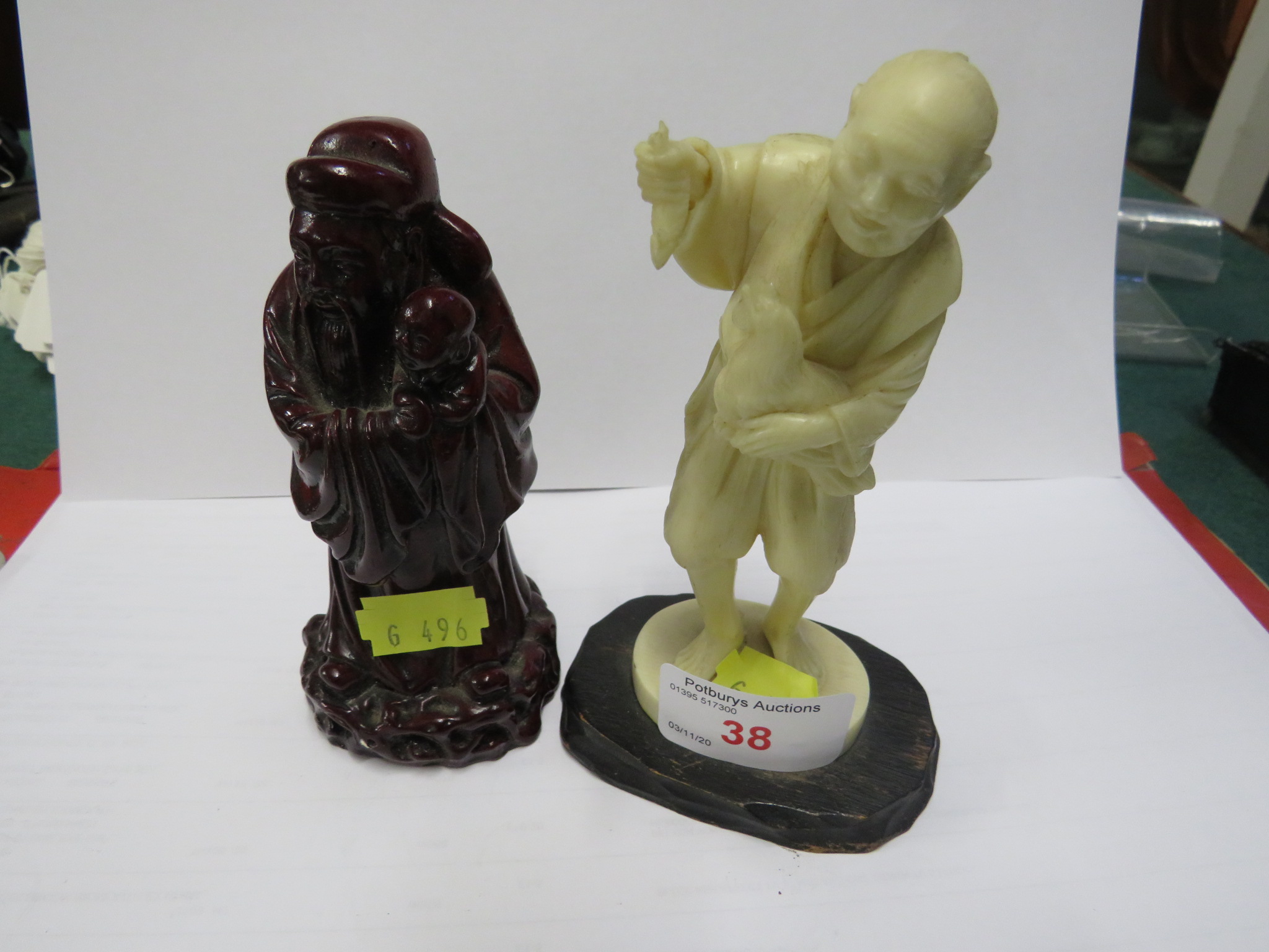 CHINESE STYLE RESIN FIGURE OF MAN WITH CHICKEN, AND DARK RED RESIN FIGURE OF ROBED WISE MAN WITH