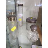 THREE ETCHED GLASS BOTTLES WITH SILVER LIDS, SMALL CUT GLASS SCENT BOTTLE WITH SILVER LID, AND A CUT