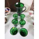 GREEN GLASS JUG AND SIX BEAKERS WITH SILVERED DECORATION