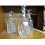 THREE CUT GLASS STOPPERED DECANTERS