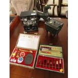 TWO CASED CHINESE BRUSH AND CALLIGRAPHY SETS, FIGURAL TABLE LIGHTER AND CAST METAL CIGARETTE BOX