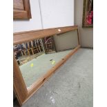 LONG WALL MIRROR IN A PINE FRAME TOGETHER WITH ONE OTHER LONG MIRROR IN A CREAM FRAME