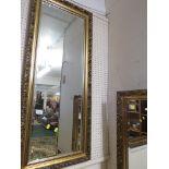 LONG RECTANGULAR WALL MIRROR IN A GILT EFFECT FRAME