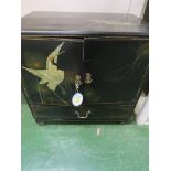BLACK LACQUERED FAR EASTERN CHEST WITH TWO CUPBOARD DOORS ENCLOSING THREE DRAWERS, A SINGLE DRAWER