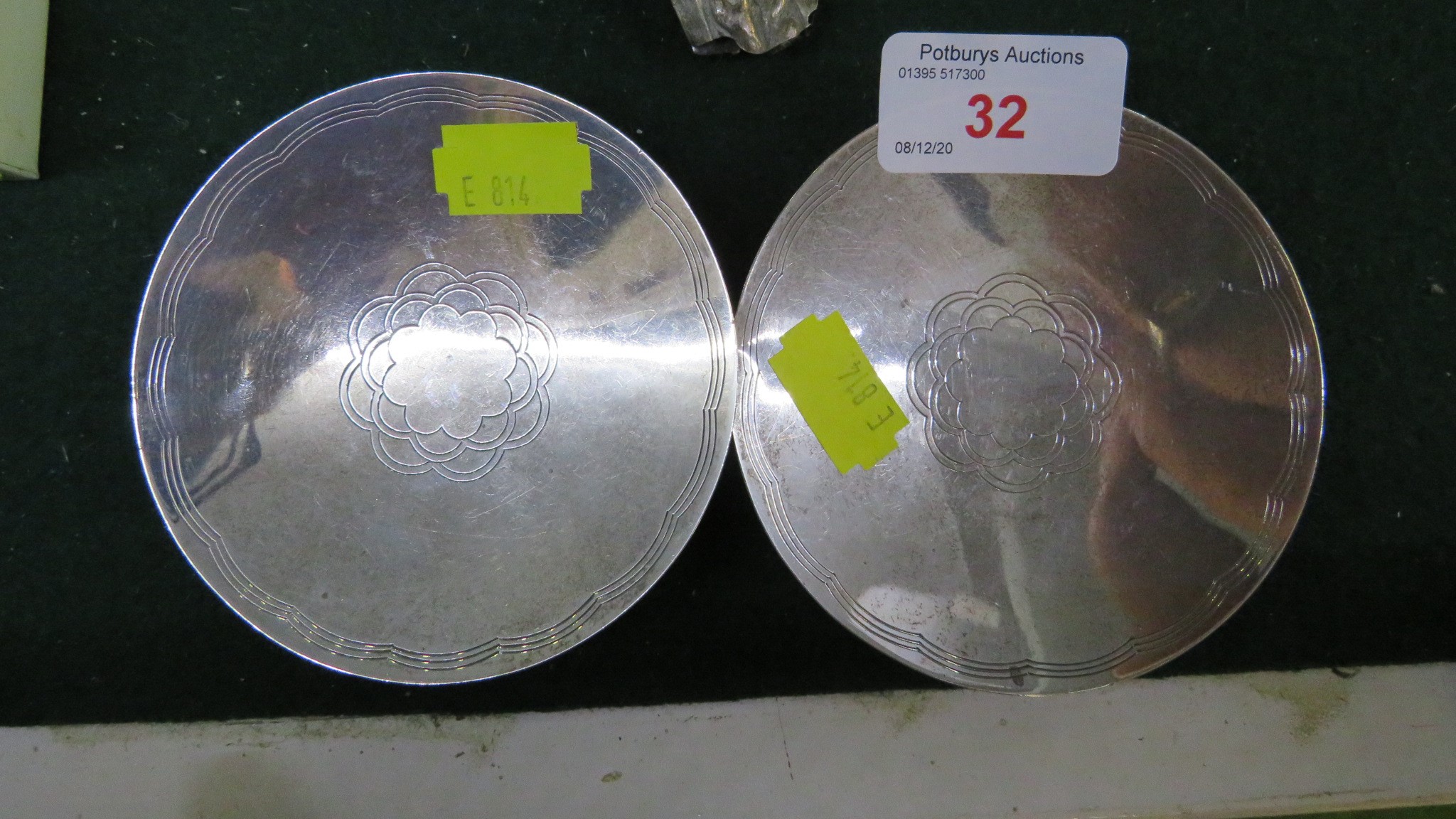 A PAIR OF SMALL CIRCULAR INDIAN WHITE METAL DISHES STAMPED WITH ELEPHANT AND OTHER STAMPED MARKS (