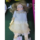 A SIMON AND HALBIG SMALL CHINA HEADED DOLL WITH OPEN GLASS EYES DRESSED IN A VINTAGE DRESS