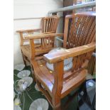 A PAIR OF STAINED HARDWOOD PATIO ARMCHAIRS